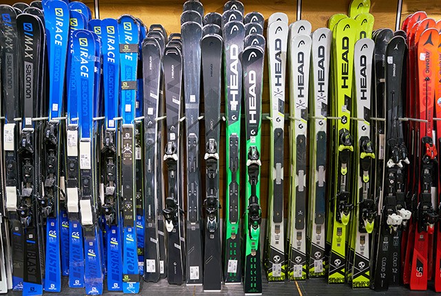 Skis lined up in gear shop.